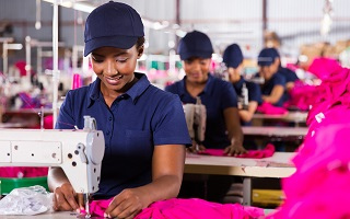 Female sewing pink cloth