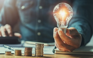 Guy holding a lighted bulb